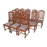 A set of twelve mid 20th century Dutch style, carved chestnut dining chairs with grey leatherette