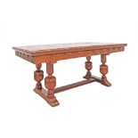 A mid 20th century Dutch style carved chestnut extendable dining / library table, the top with