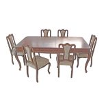 An Art Deco revival carved walnut and figured veneered top dining room table on cabriole legs
