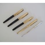 A collection of five pens comprising three fountain pens with gold cups, a gold ball pen and a