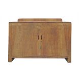 An Art Deco revival blonde walnut veneered dresser with two doors enclosing a cupboard and