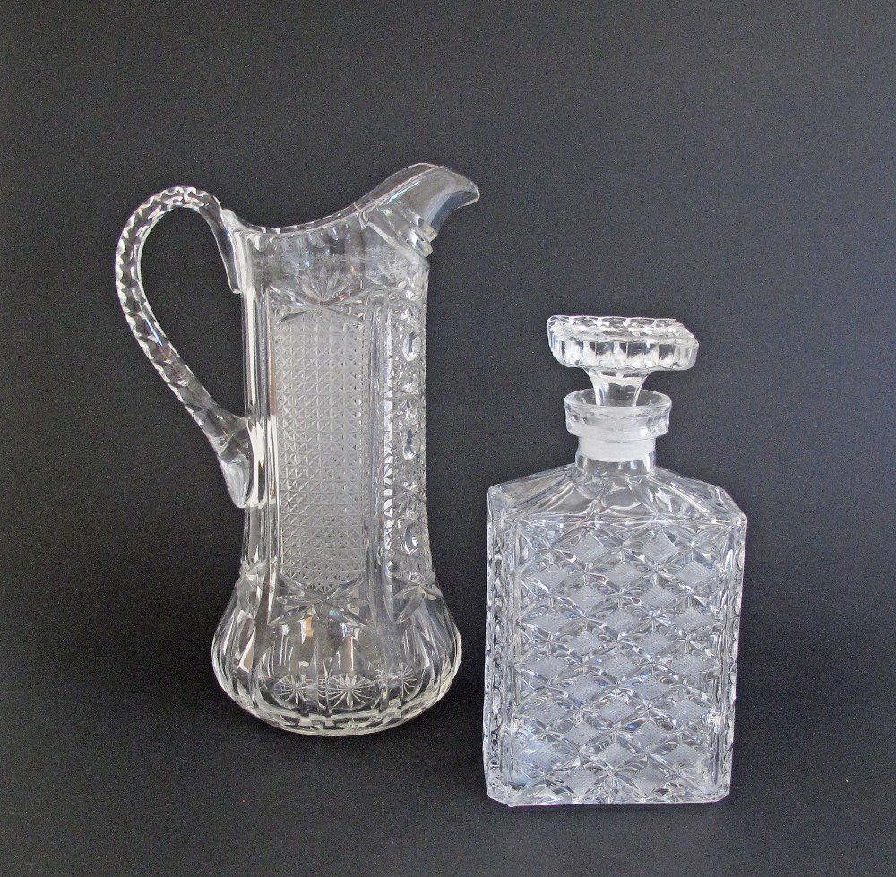 A finely cut square glass decanter with stopper H22cm and a finely cut crystal pitcher H29cm