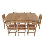 An Art Deco revival blonde walnut veneered dining suite comprising an extendable table, six solid