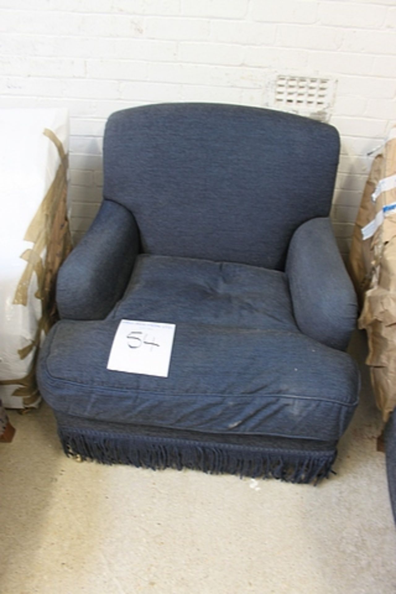 A blue upholstered arm chair corduroy effect castor front legs 660mm x 750mm tall