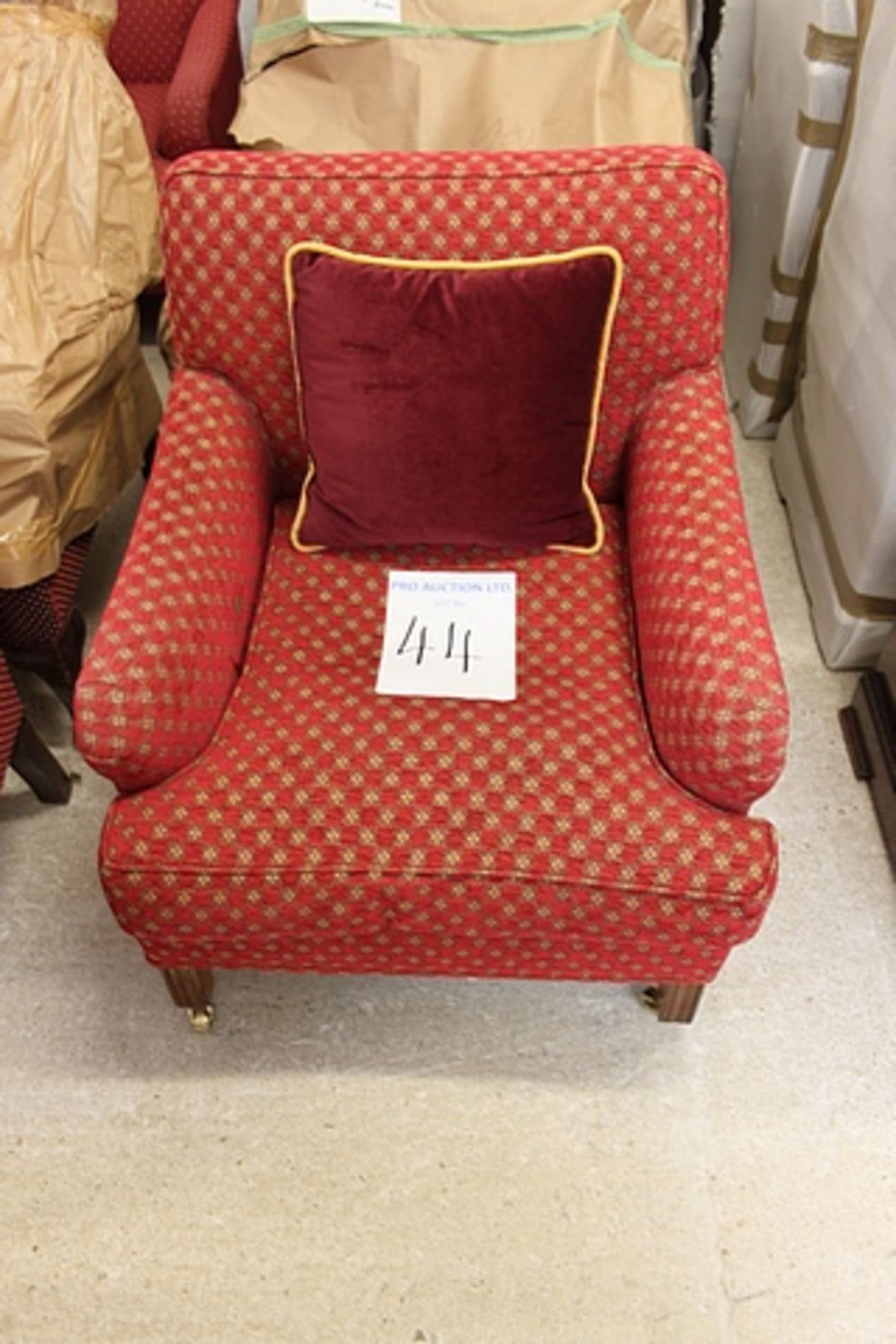 A pair of upholstered red repeating pattern armchair square back fixed cushion and loose pad seat