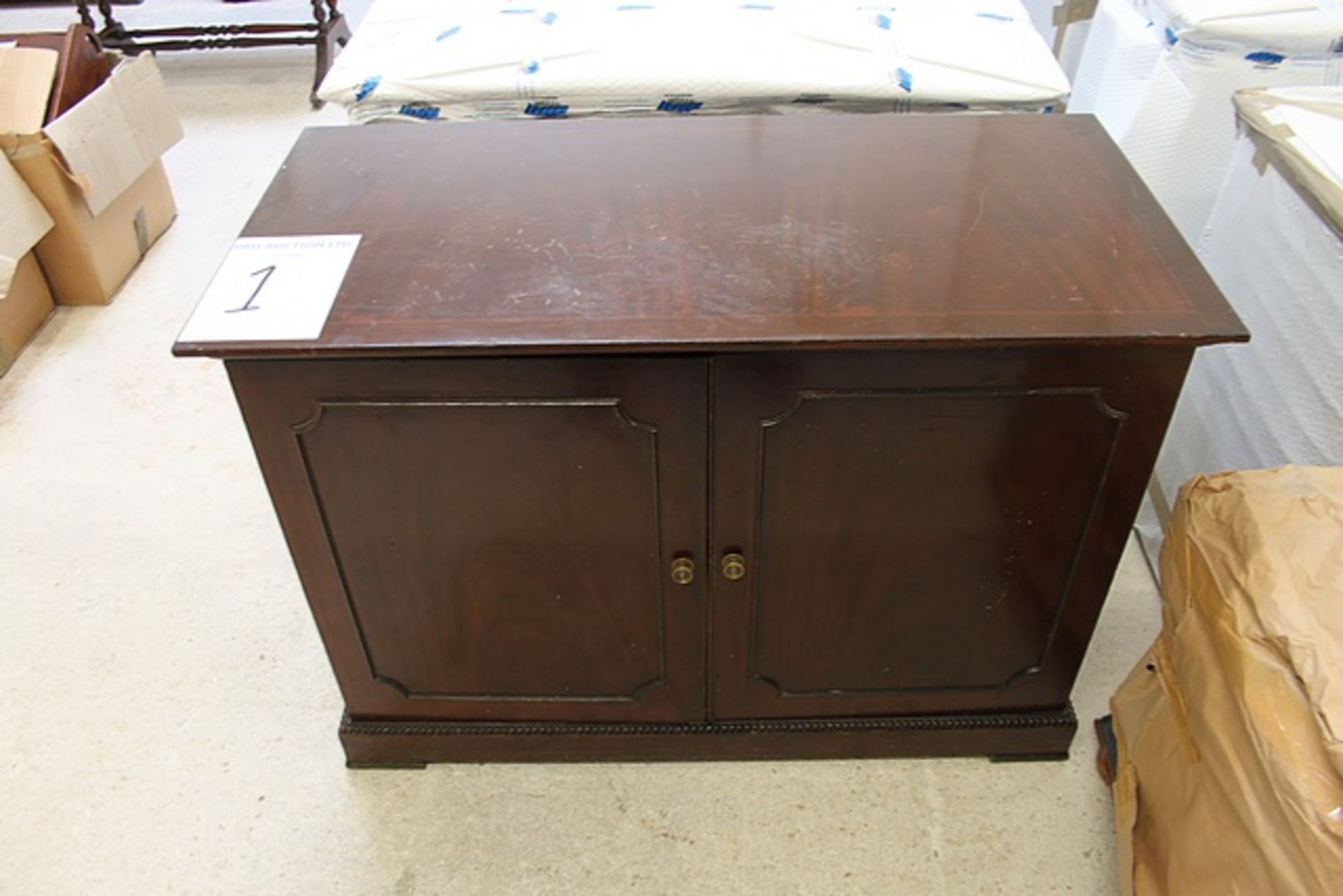 Mahogany two door cabinet panelled doors on plinth base internally fitted with a refrigerated