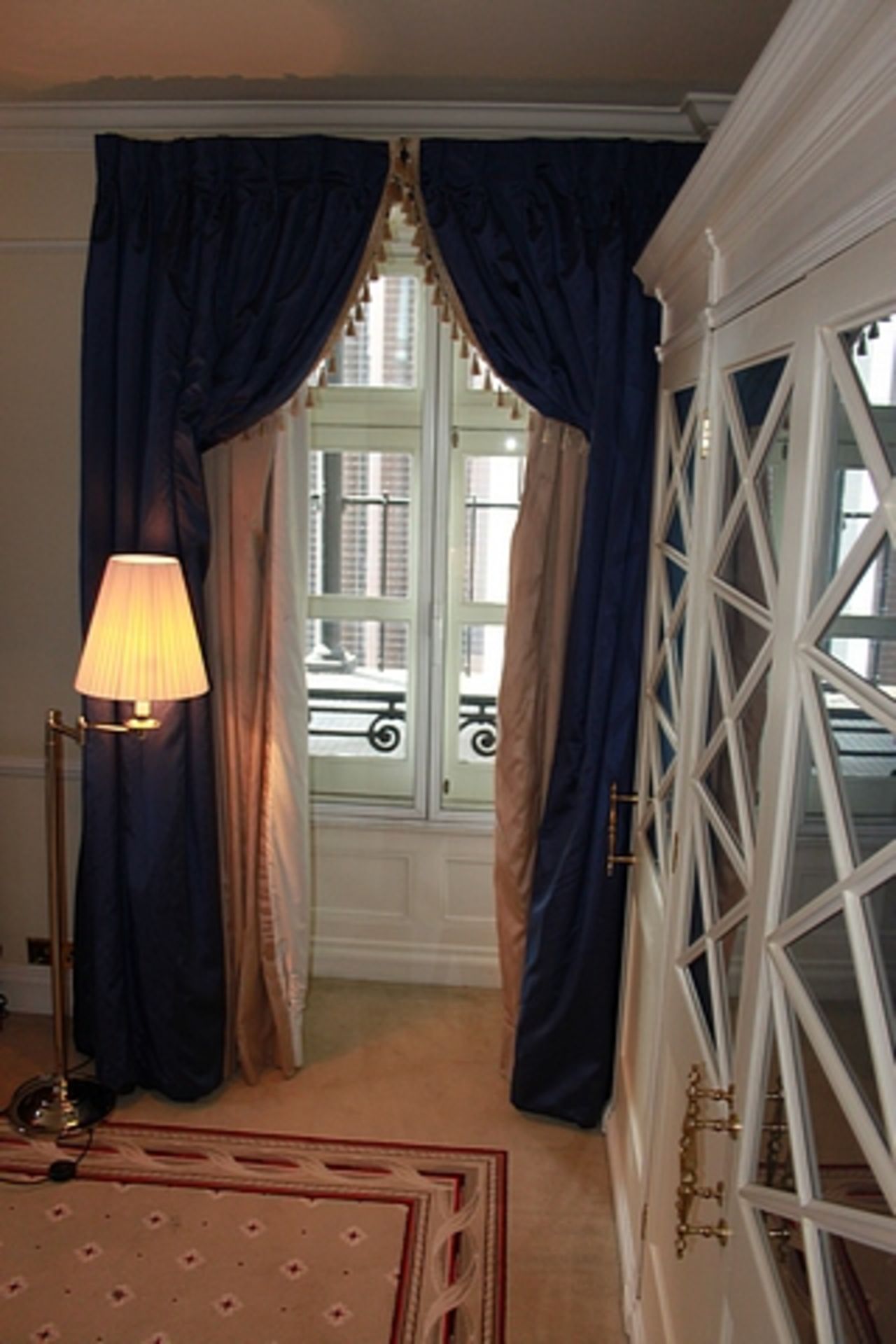 A pair of luxury lined blue curtains with decorated edge tasselling 2300mm drop