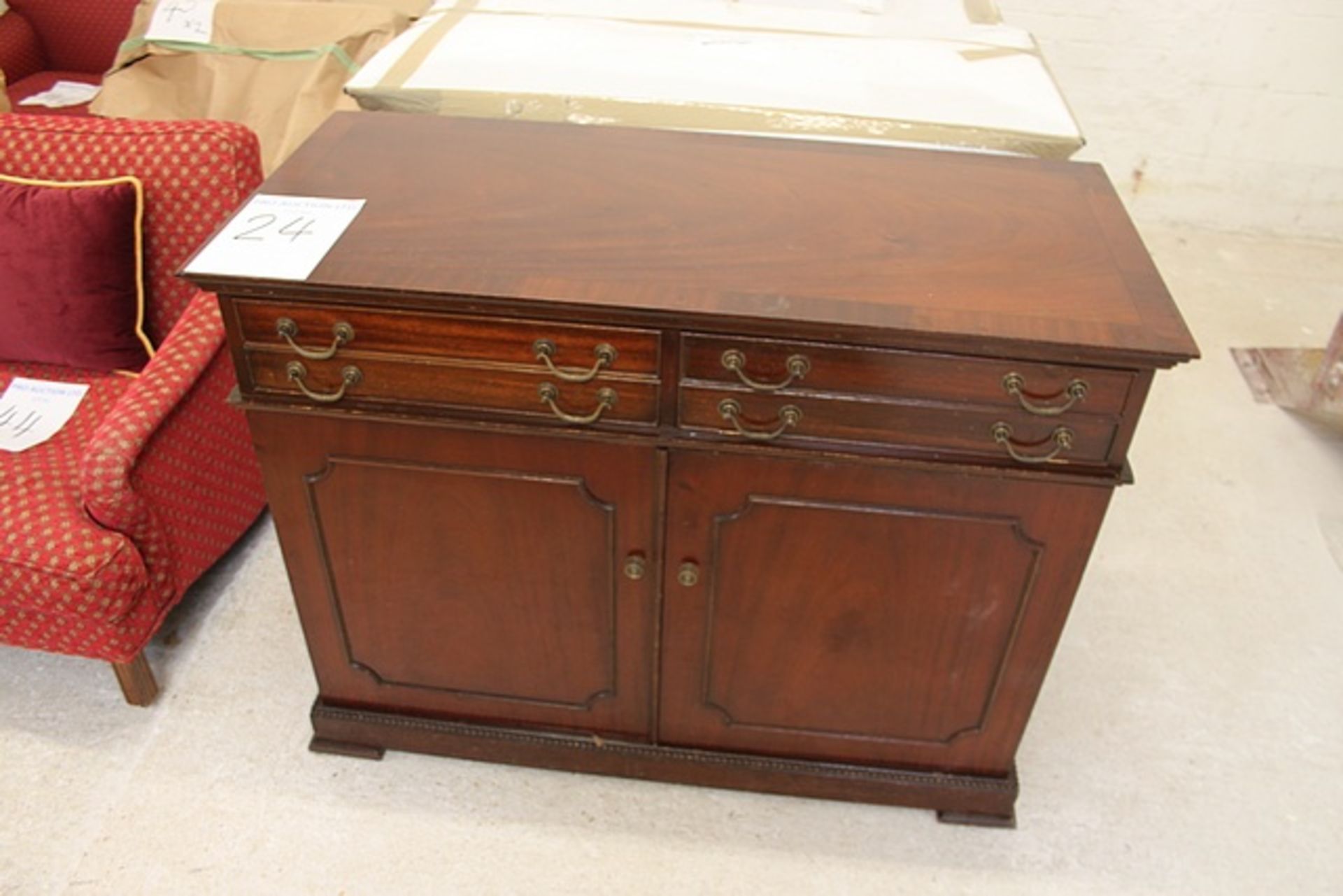 Mahogany two door cabinet panelled doors on plinth base with drop down drawer, single drawer and