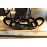 Twisted Bowl is a unique pretzel style black lacquer and cracknel black organic form that is perfect