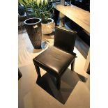 Dining Chair is hand crafted and upholstered in rustic black cow leather. The square seat is