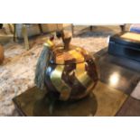 Box Apple unites brown tab, cracked polished shell and brass accents in a curvaceous and original