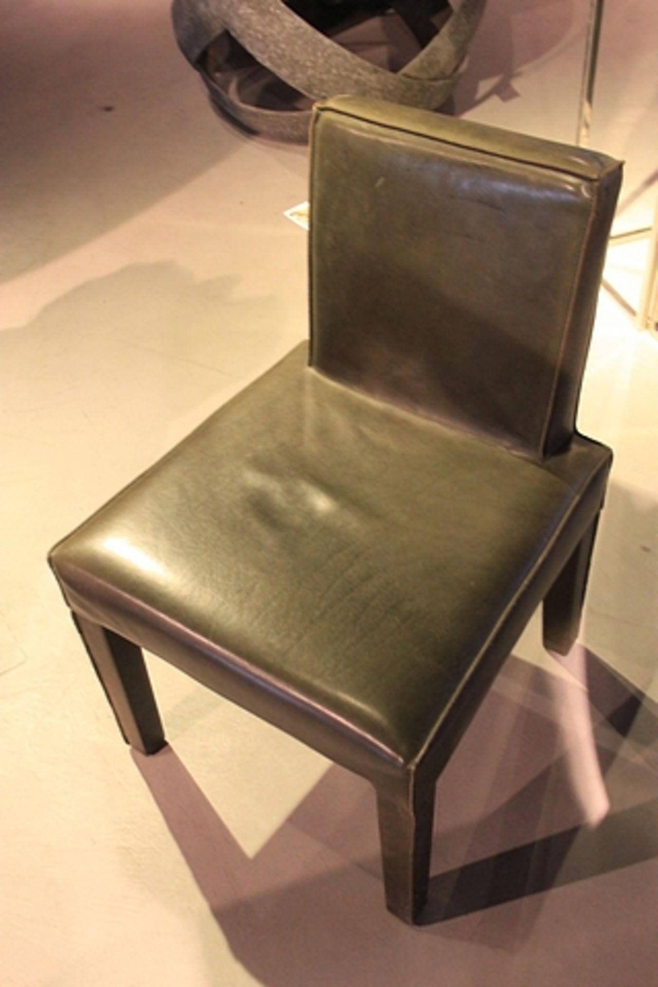 Dining Chair featuring Helsinki upholstery in rusty grey cow leather, with square seat and tilted