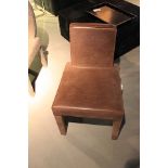 Dining Chair upholstered in rusty Helsinki brown cow leather. Features a wide seat and slightly