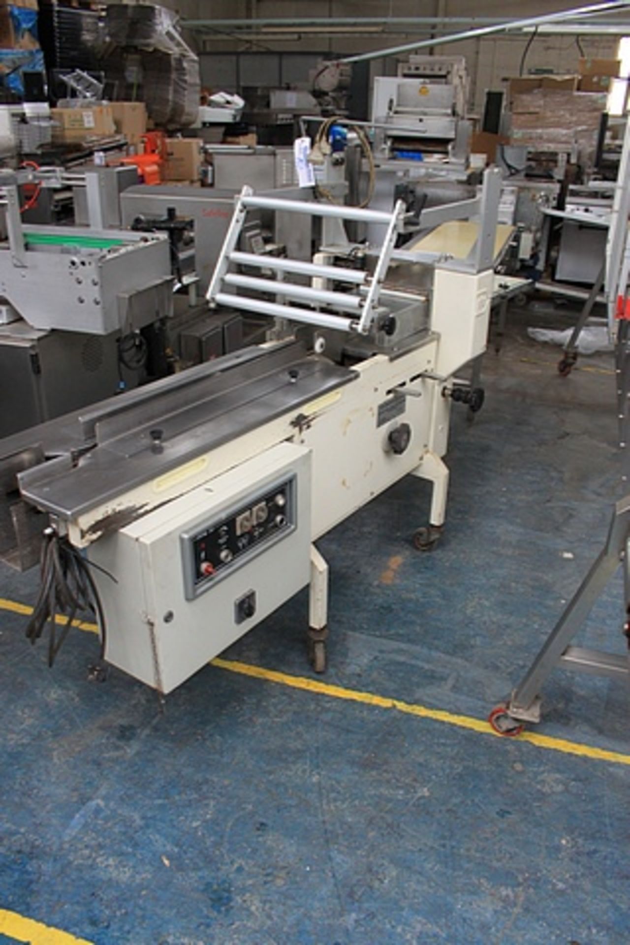 PFM30 flow wrapper with adjustable jaws infeed 950mm out feed 1100mm complete with 500mm roller belt