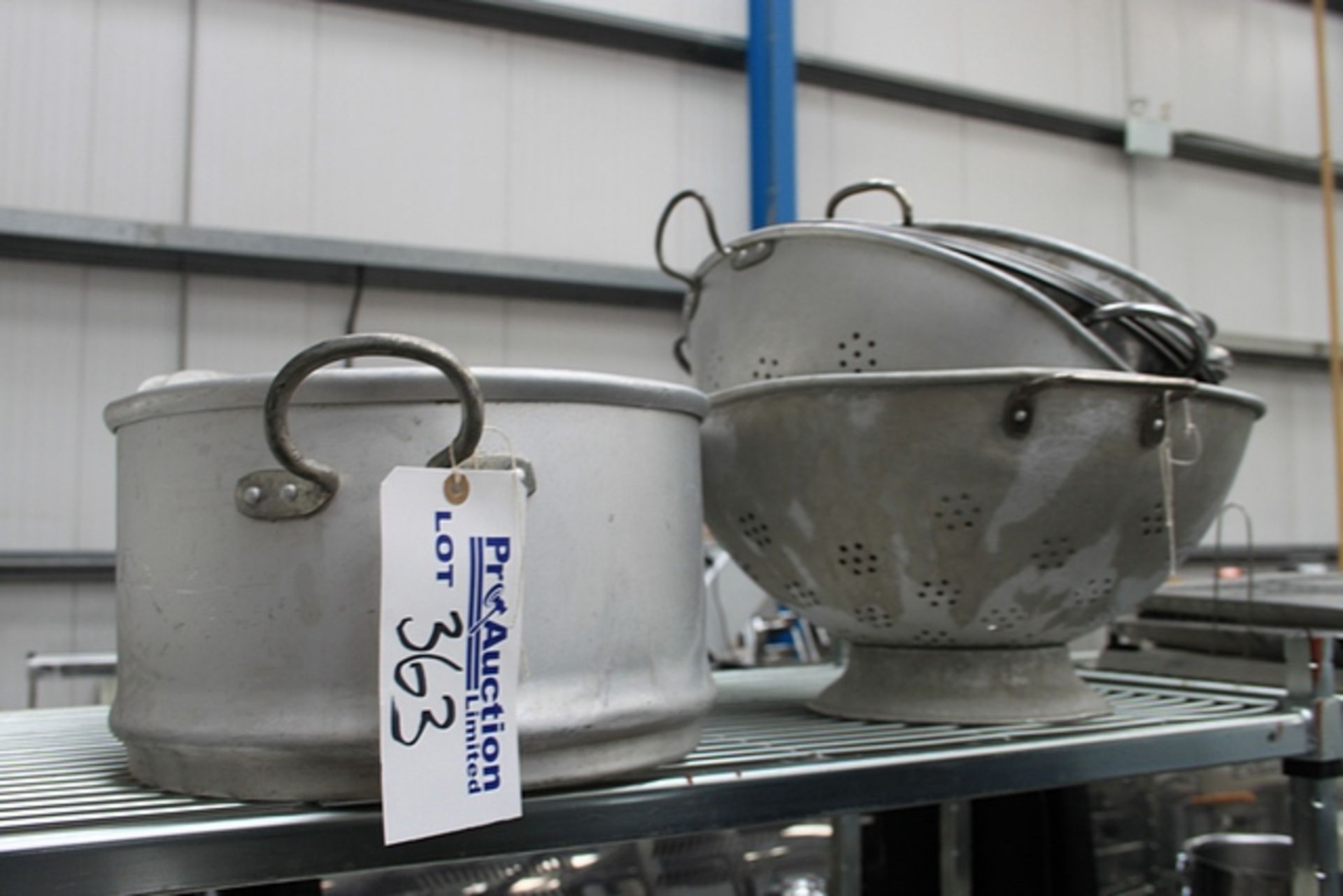 A quantity of various collanders mixing bowls and a perforated fish pan as found