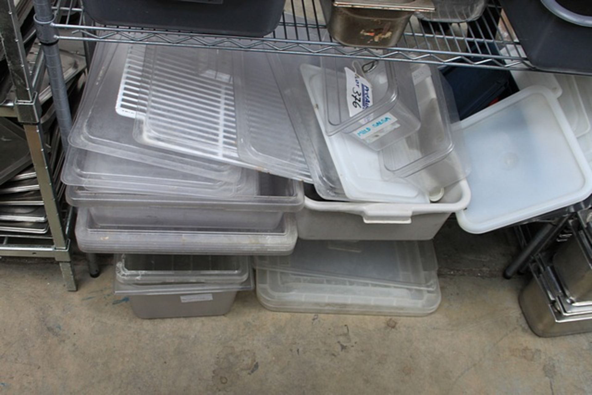 A large quantity of plastic GN pans lids and plastic trays as found