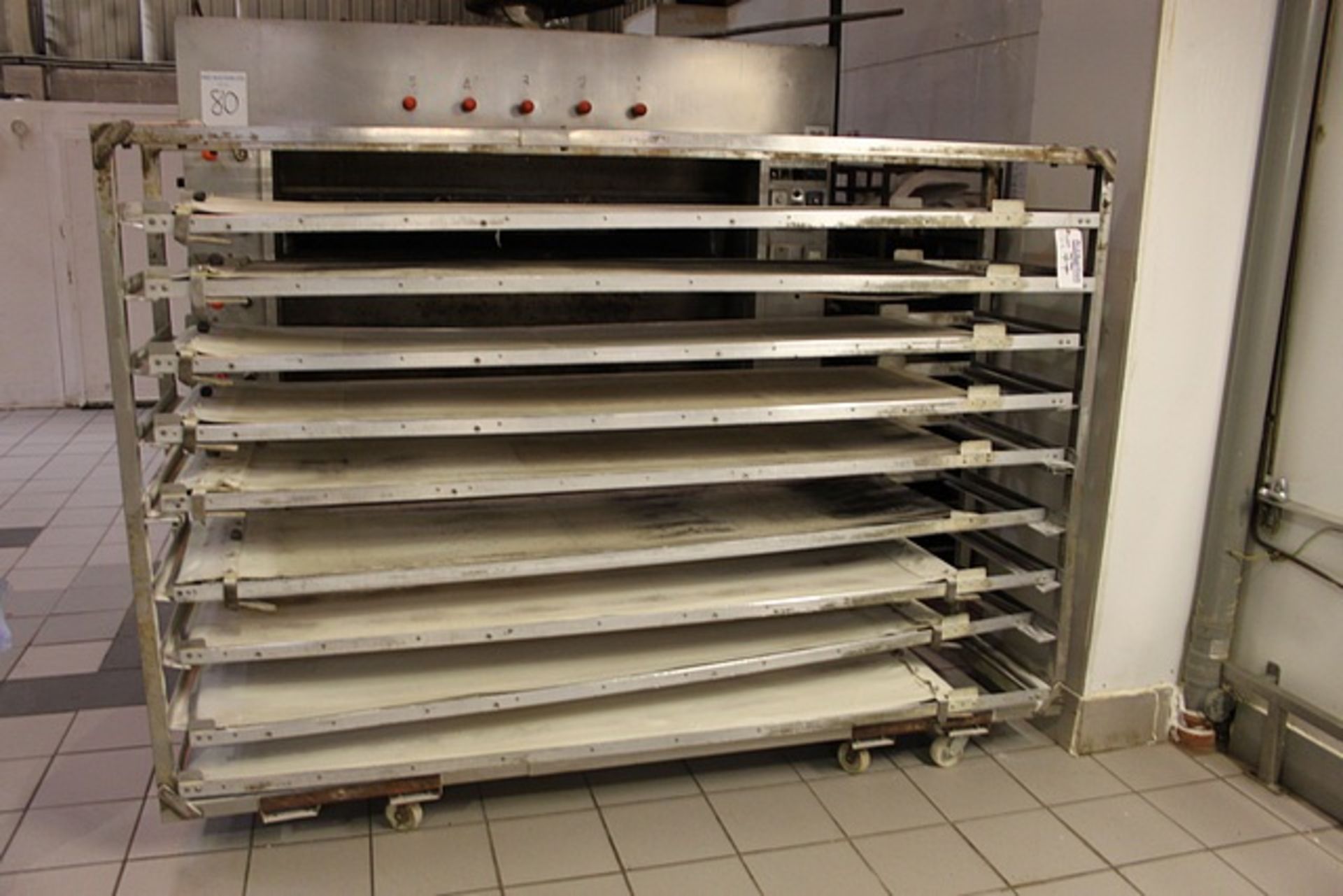 9 x manual belted sheeting tables each 2400mm x 580mm complete with stainless steel mobile rack to