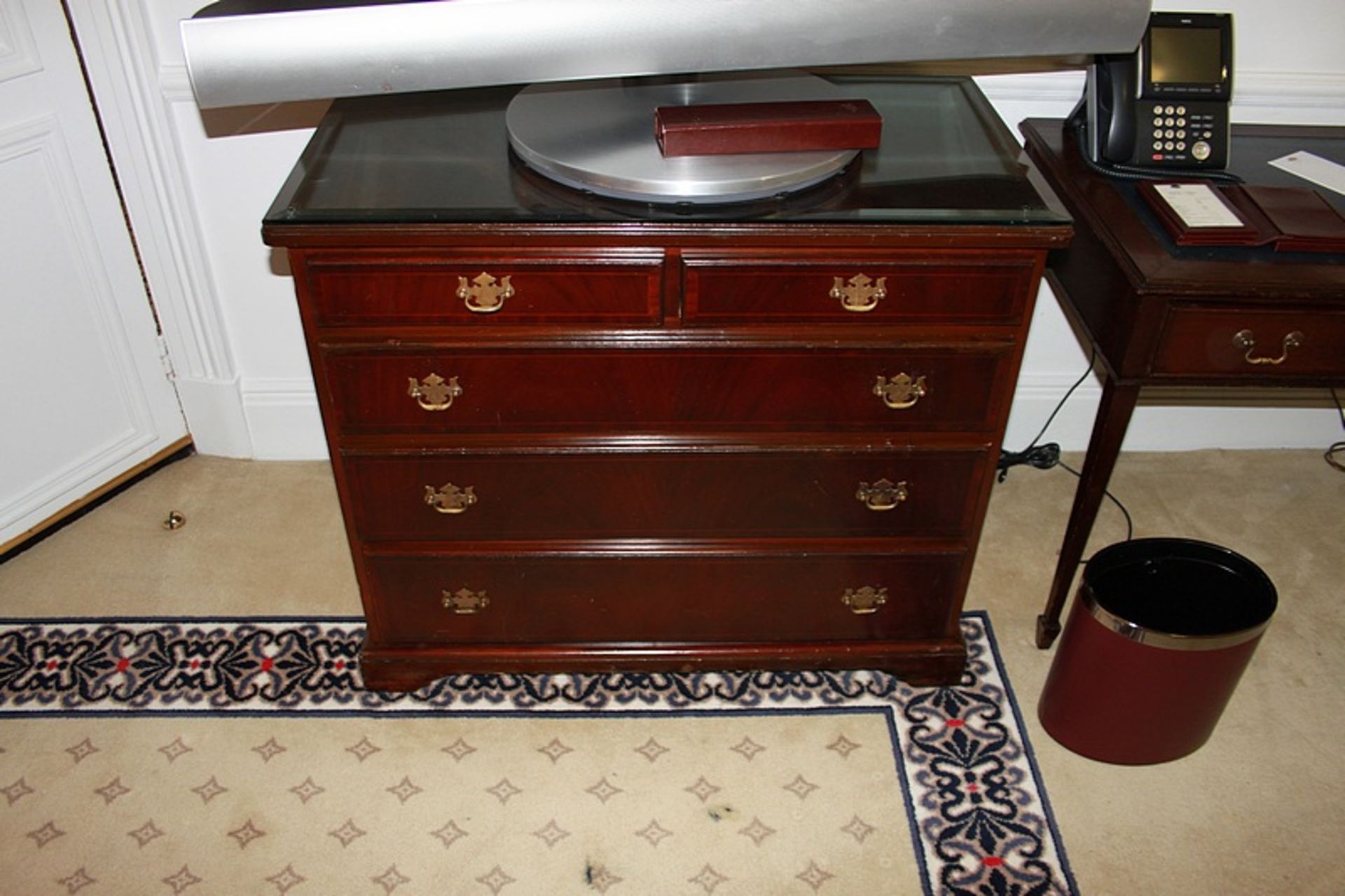 A Georgian style mahogany chest of drawers with three full and two half drawers on bracket plinth