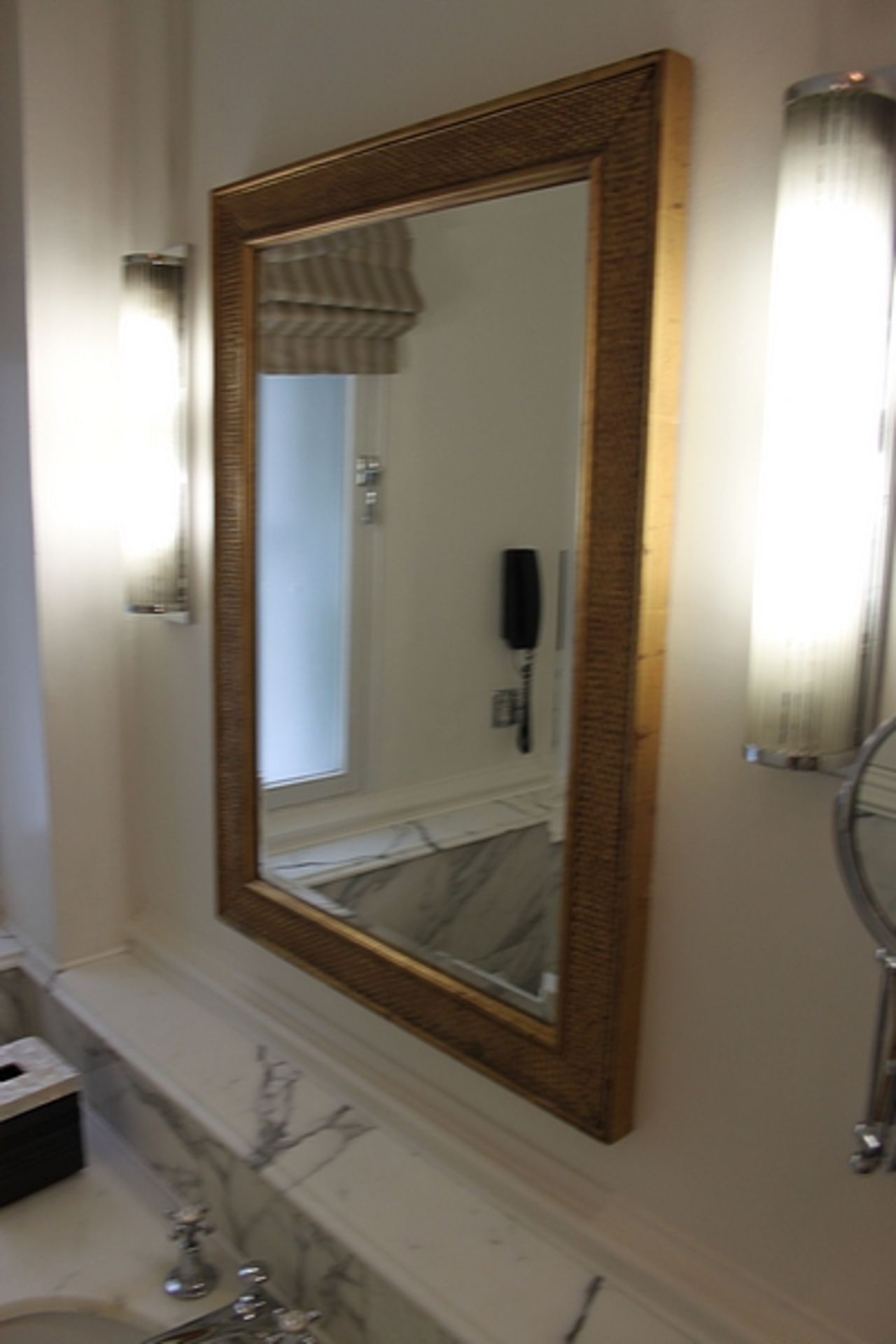 A gilt coloured framed wall mirror 650mm x 850mm