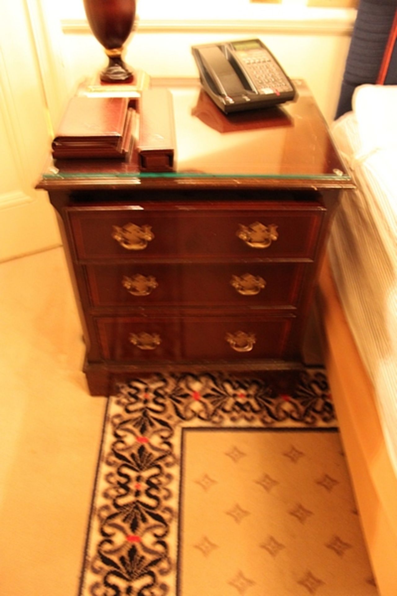 A pair of mahogany bedside cabinet chests in the Georgian style three drawers below, of dovetail