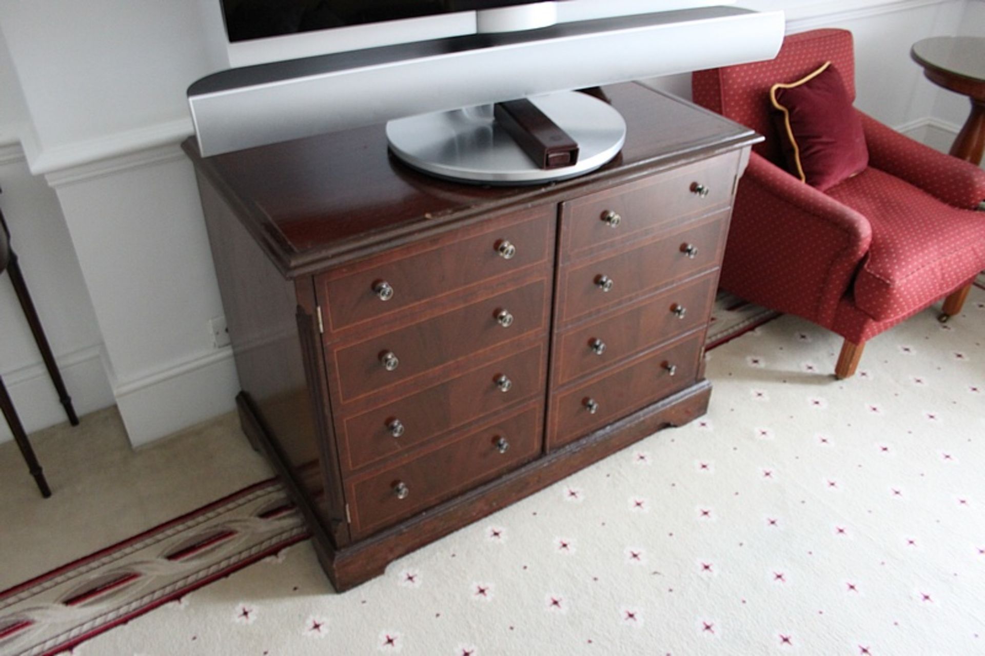 A mahogany moulded top two door cabinet the door panel with a faux drawer frontage internally fitted