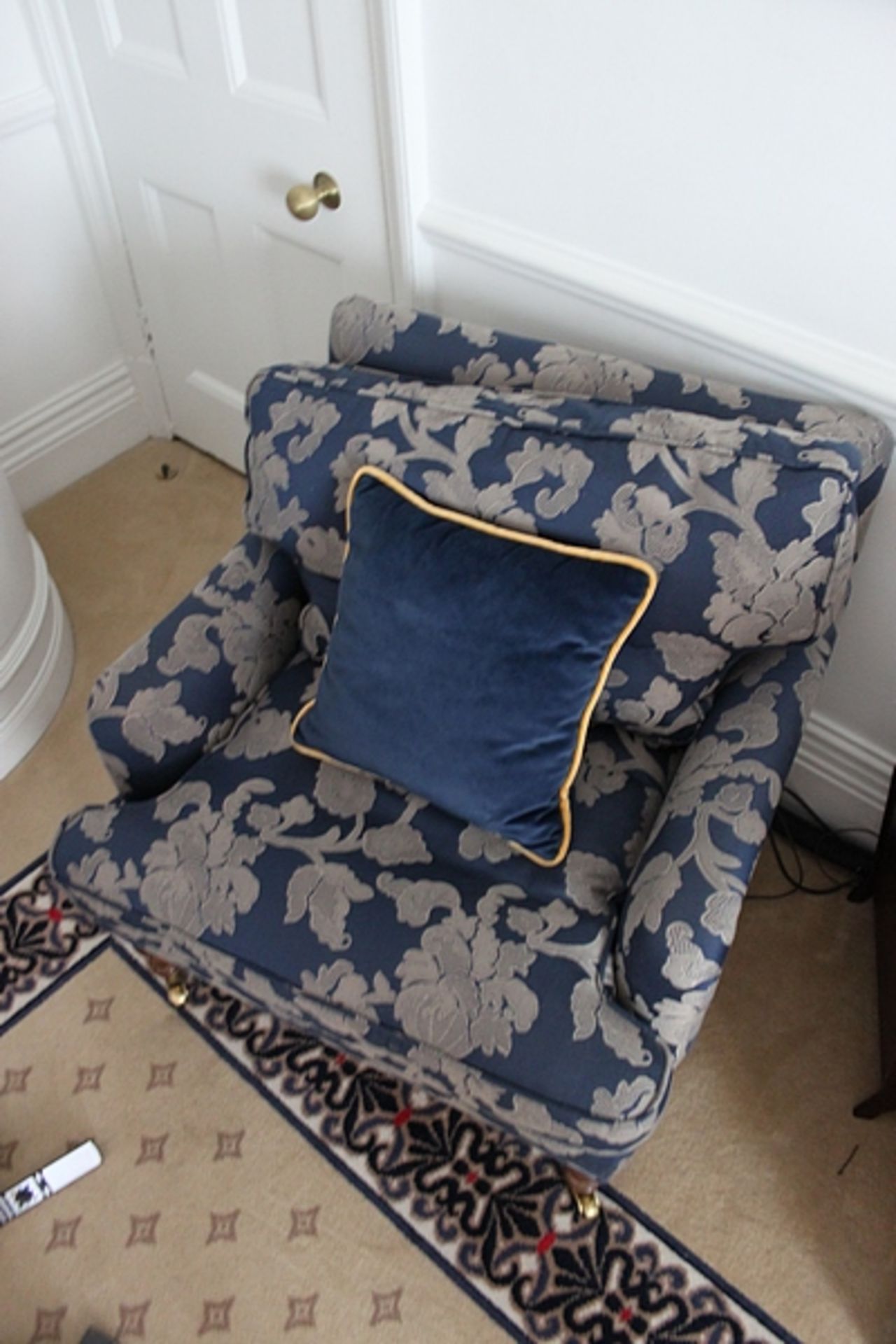 A traditional easy armchair upholstered in a blue broccade fabric solid legs 700 x 800mm