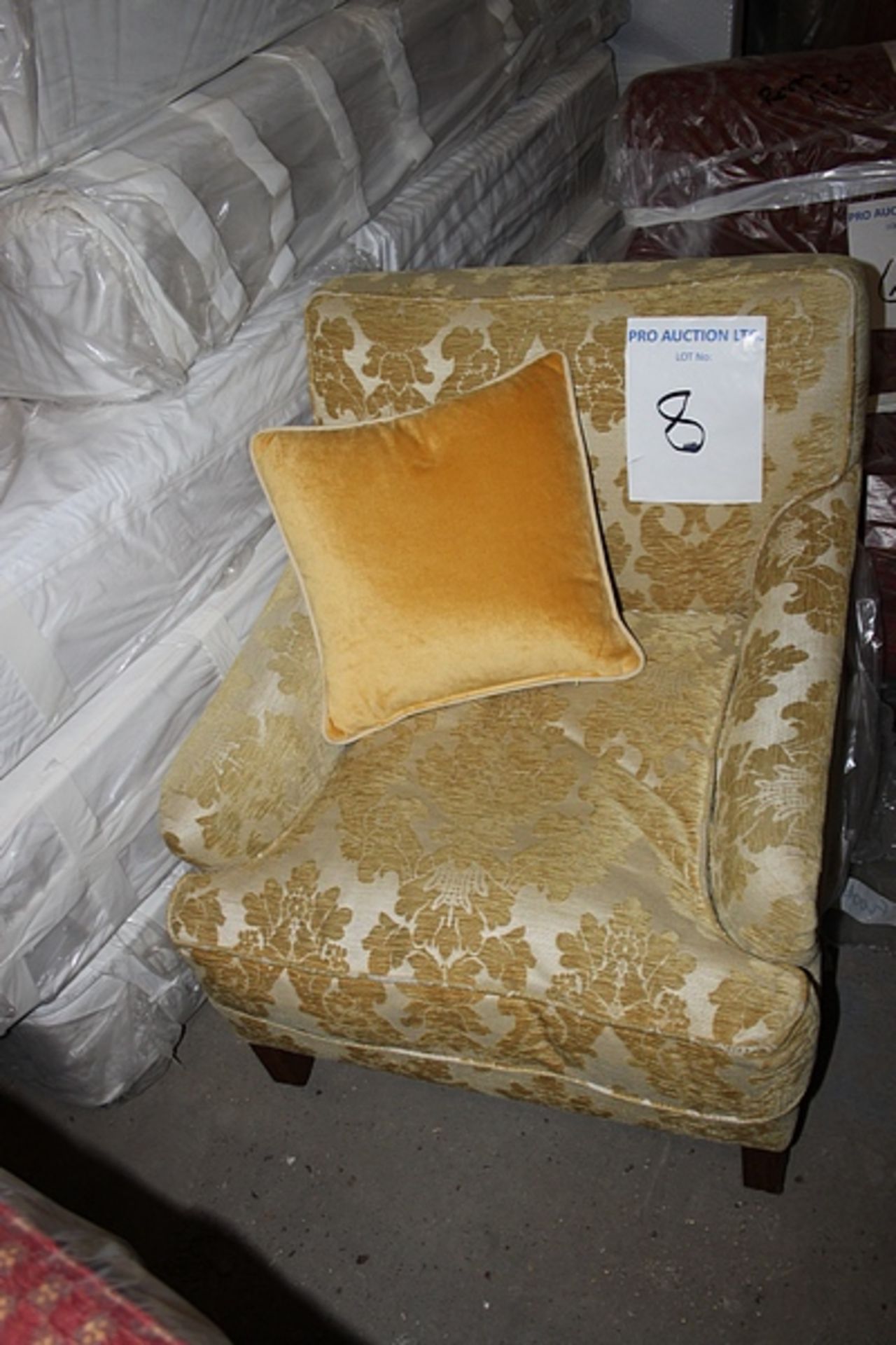 Armchair upholstered in a gold broccade fabric casters to front 700 x 800mm