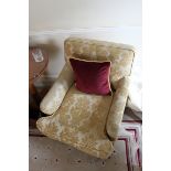 A pair of armchairs upholstered in gold yellow fabric casters to front 700mm x 800mm