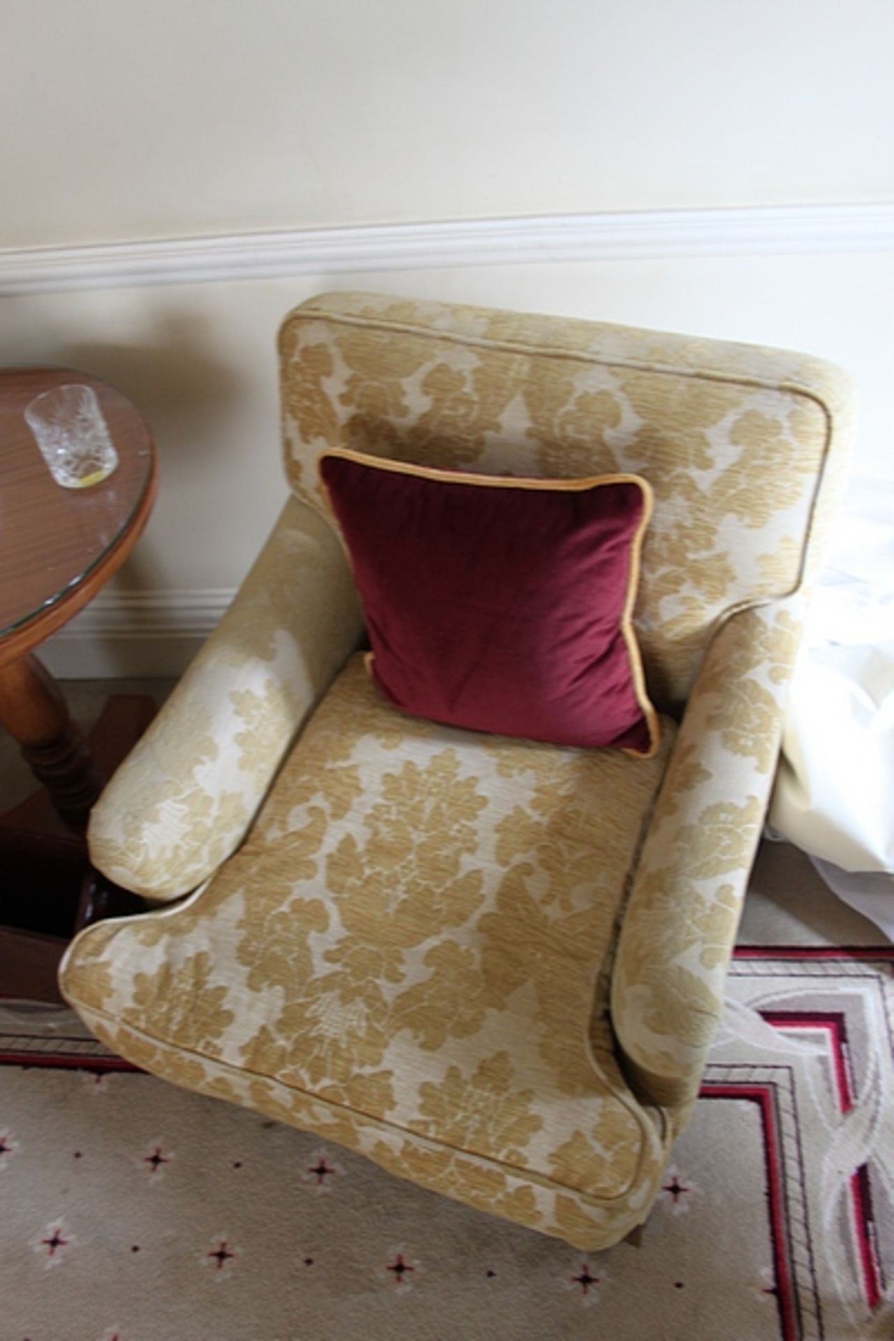 A pair of armchairs upholstered in gold yellow fabric casters to front 700mm x 800mm