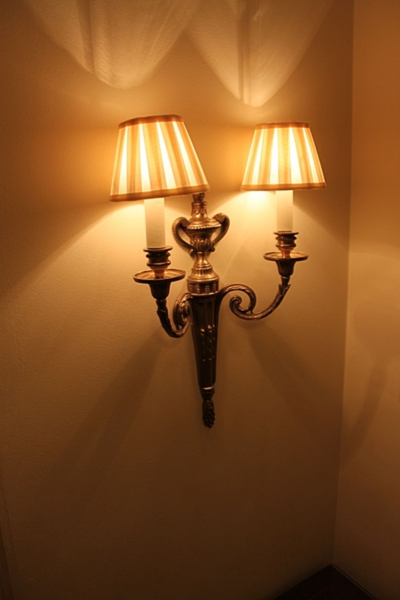 A pair of Georgian styled twin arm wall sconces