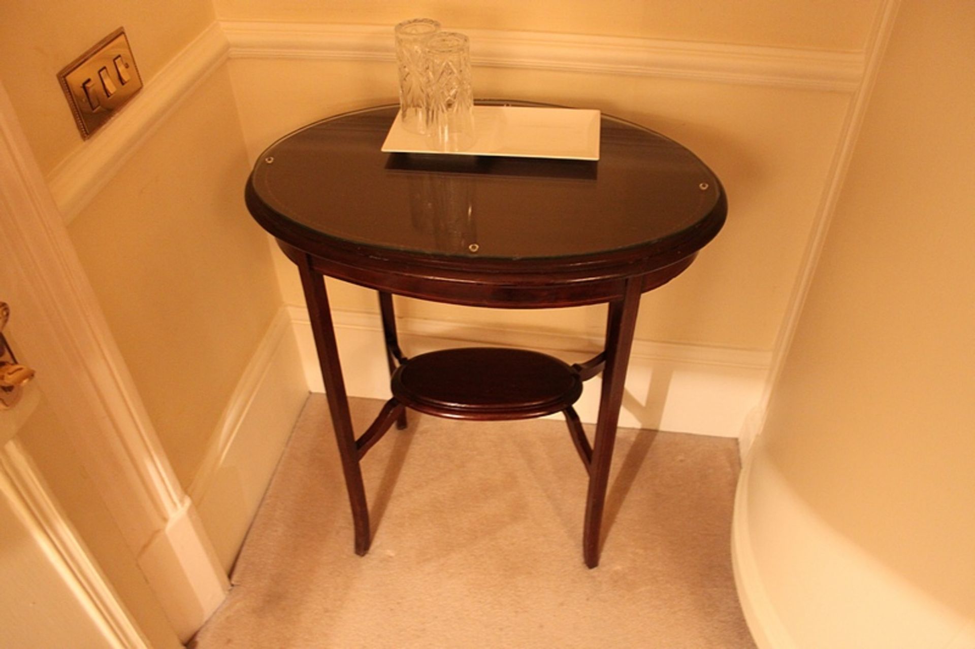 A pair of mahogany ovoid tables with low shelves 520mm x 360mm