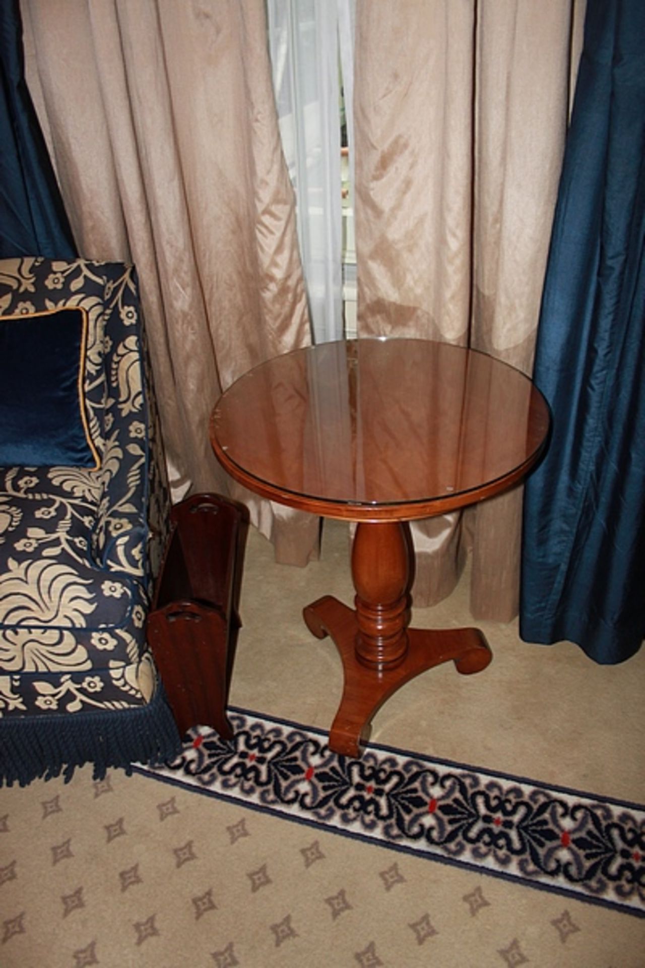 A light mahogany circular top table on carved baluster column and raised on a tri-form base with