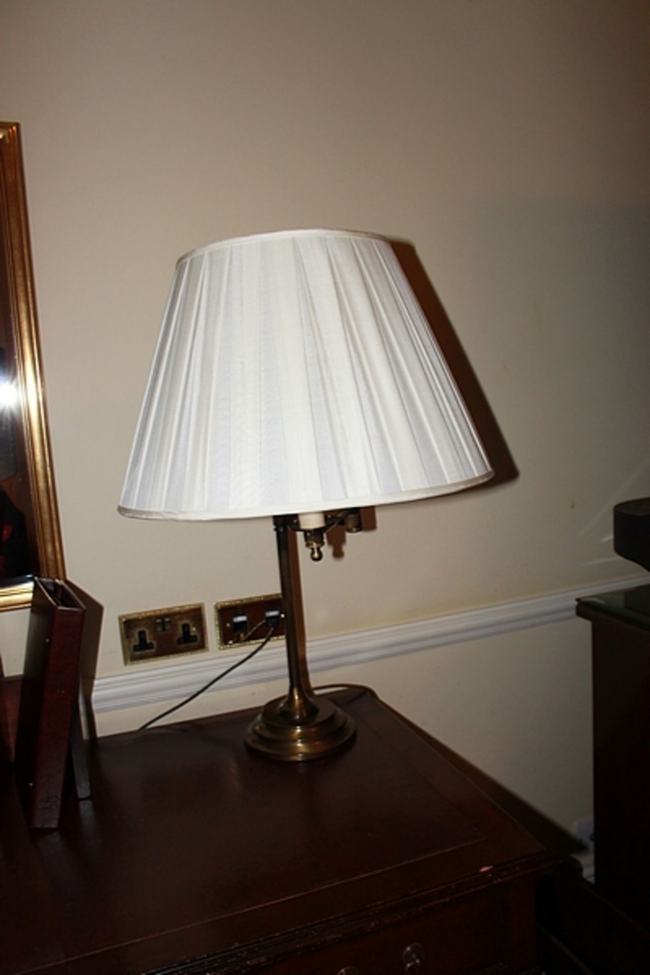 A brass swivel arm table lamp