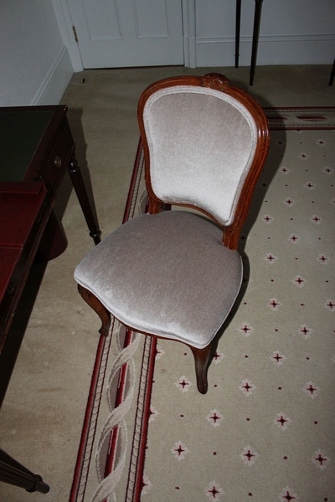 A solid wood framed side chair upholstered in velveteen oyster