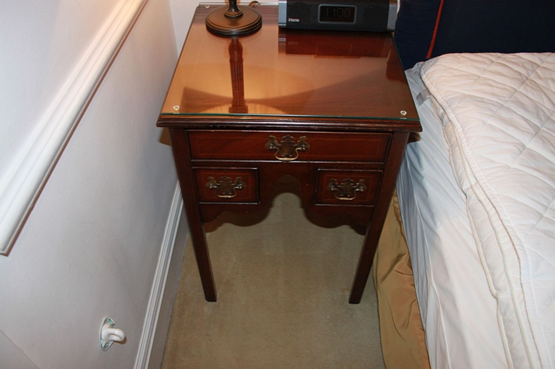 A pair Georgian style bedside cabinets a single drawer below the moulded top with two smaller