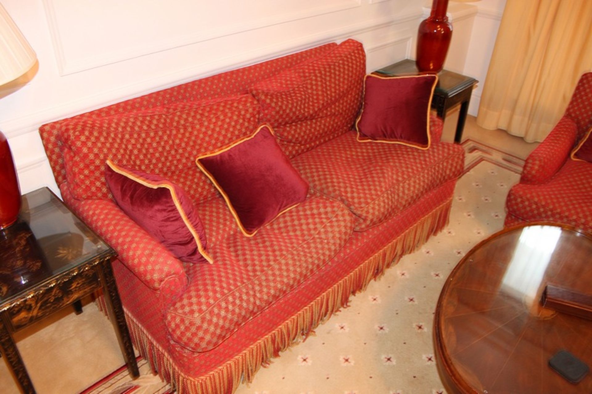 A two seater sofa upholstered in red fabric with repeating red check pattern 1650mm x 800mm