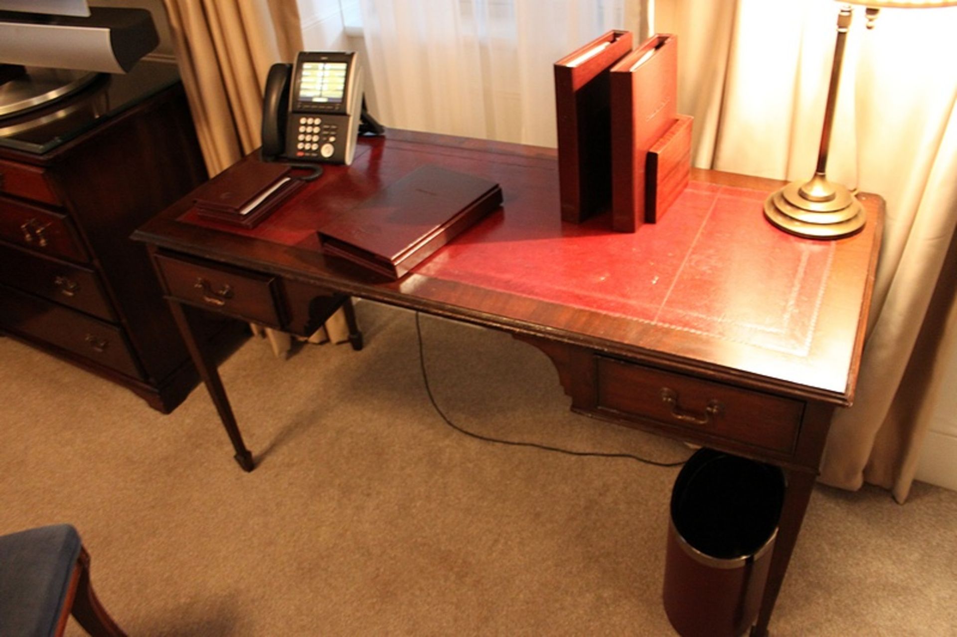 A mahogany Georgian style writing table featuring a leather top above two drawers supported by