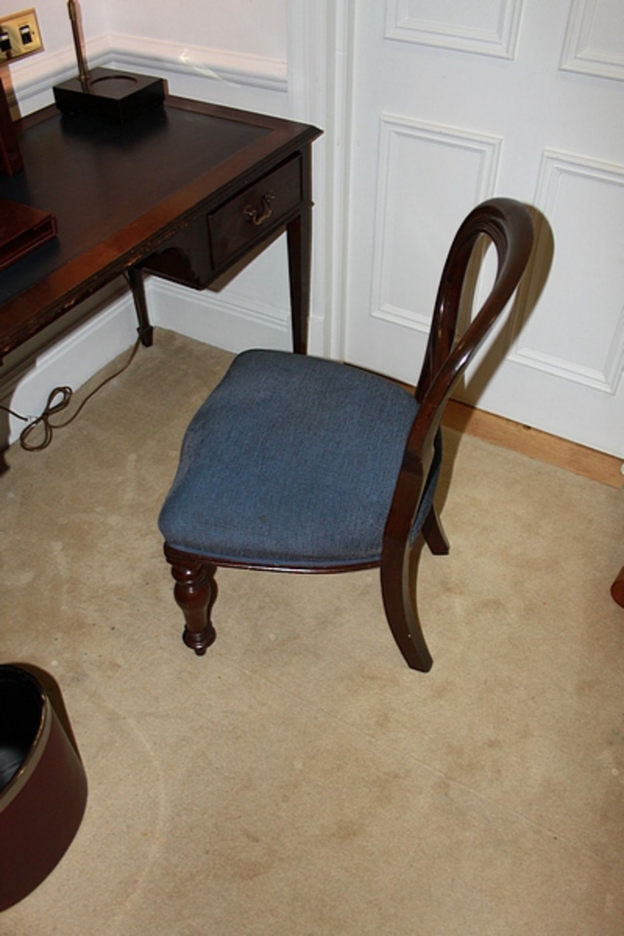 A mahogany wood Georgian style armchair upholstered in blue fabric