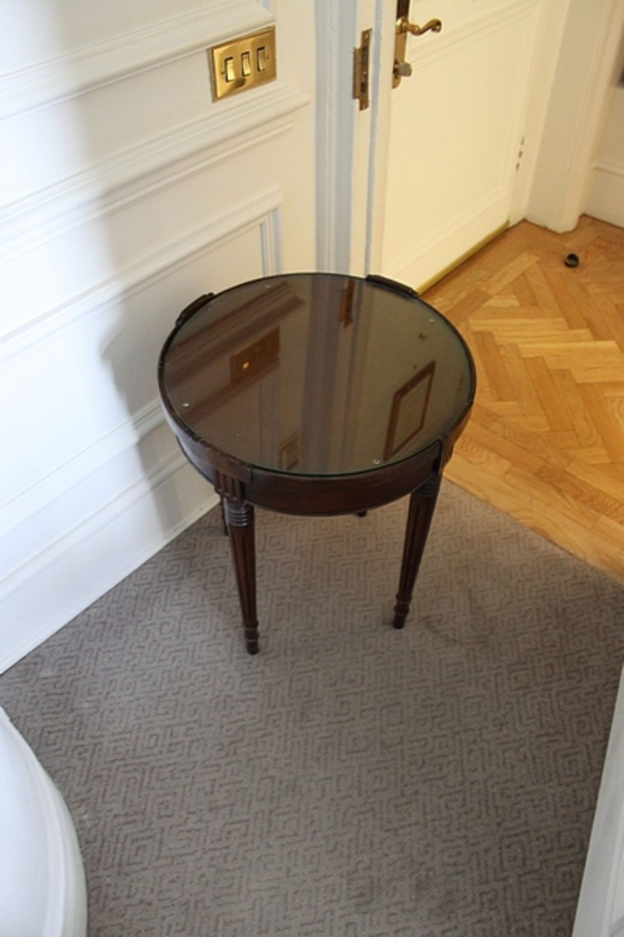 A mahogany circular occassional table with inlay mounted on square tapering legs 550mm