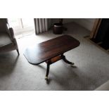 A Georgian style mahogany coffee table shaped supports stood on a platform base with four outswept