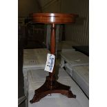 A Georgian style mahogany circular top table on carved baluster column and raised on a tri-form base