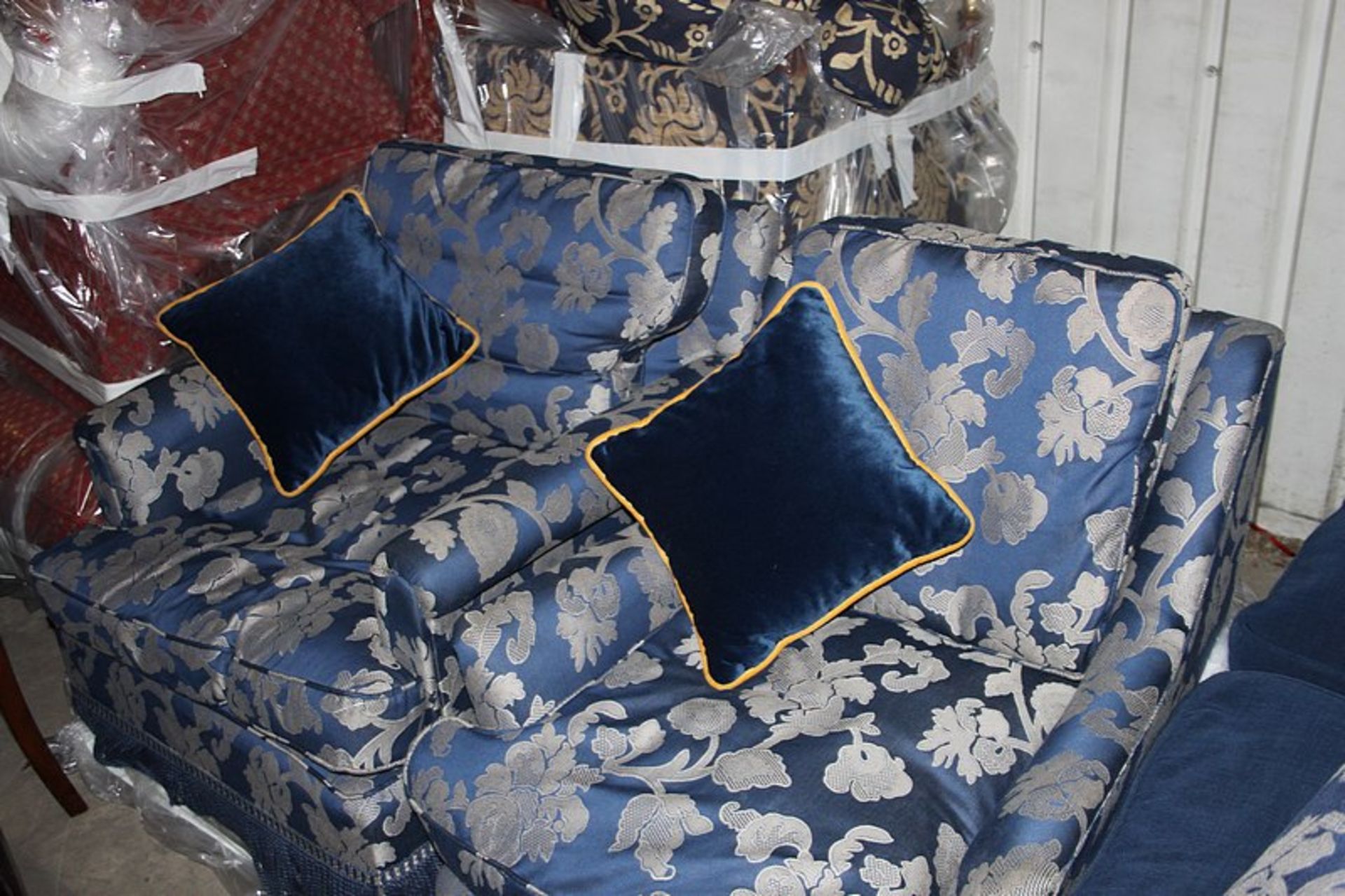 A set of 2 traditional easy armchairs one wide frame and the other narrow frames upholstered in blue