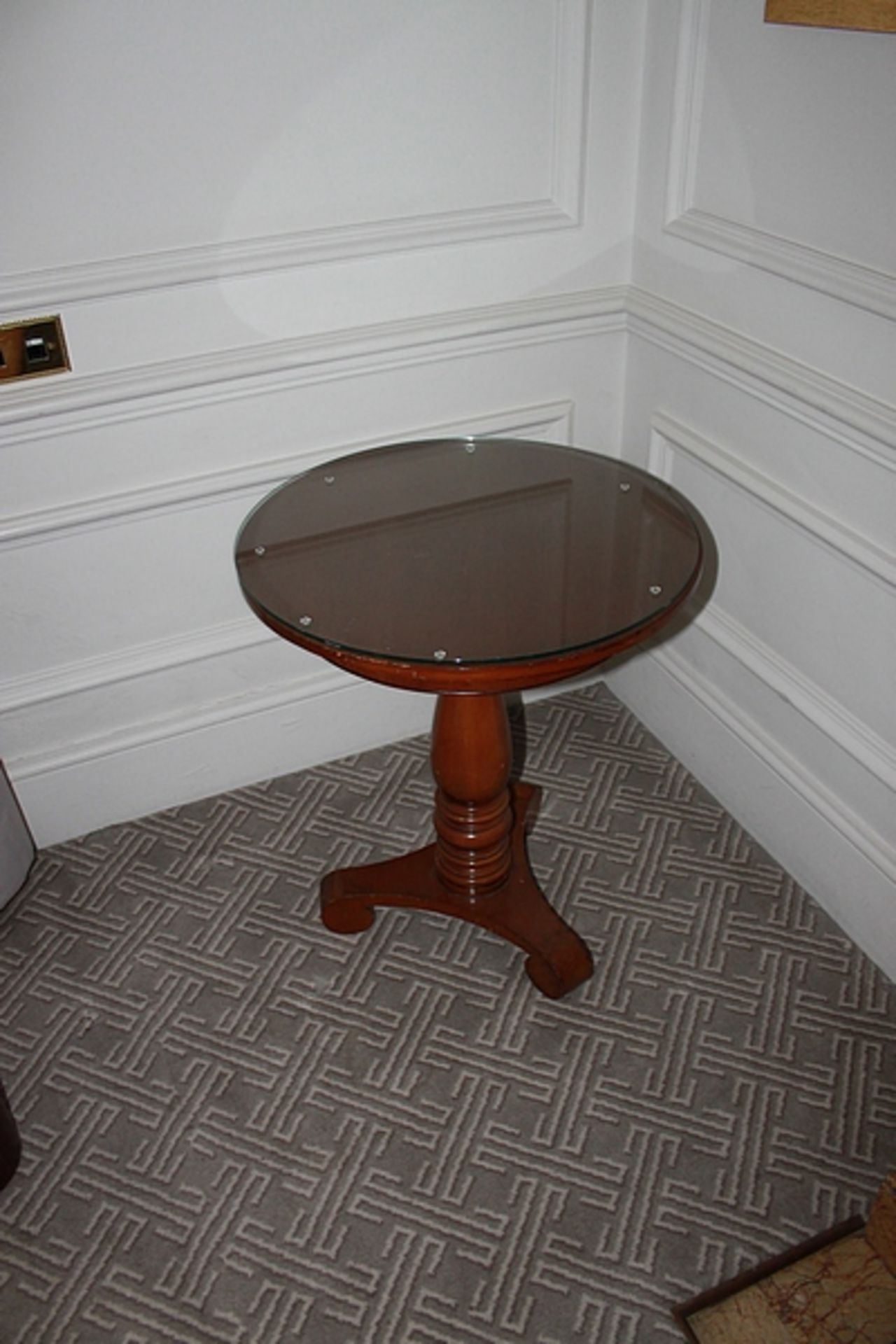 A pair light mahogany circular top table on carved baluster column and raised on a tri-form base