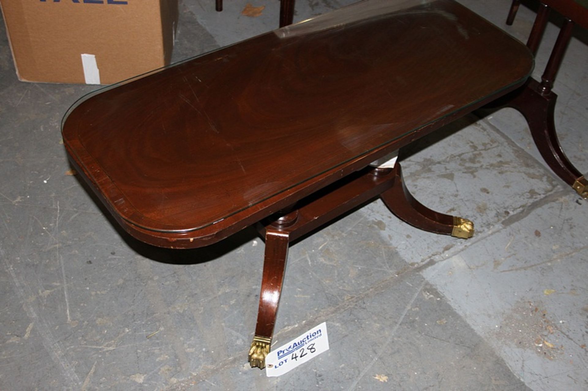 A Georgian style mahogany coffee table shaped supports stood on a platform base with four outswept