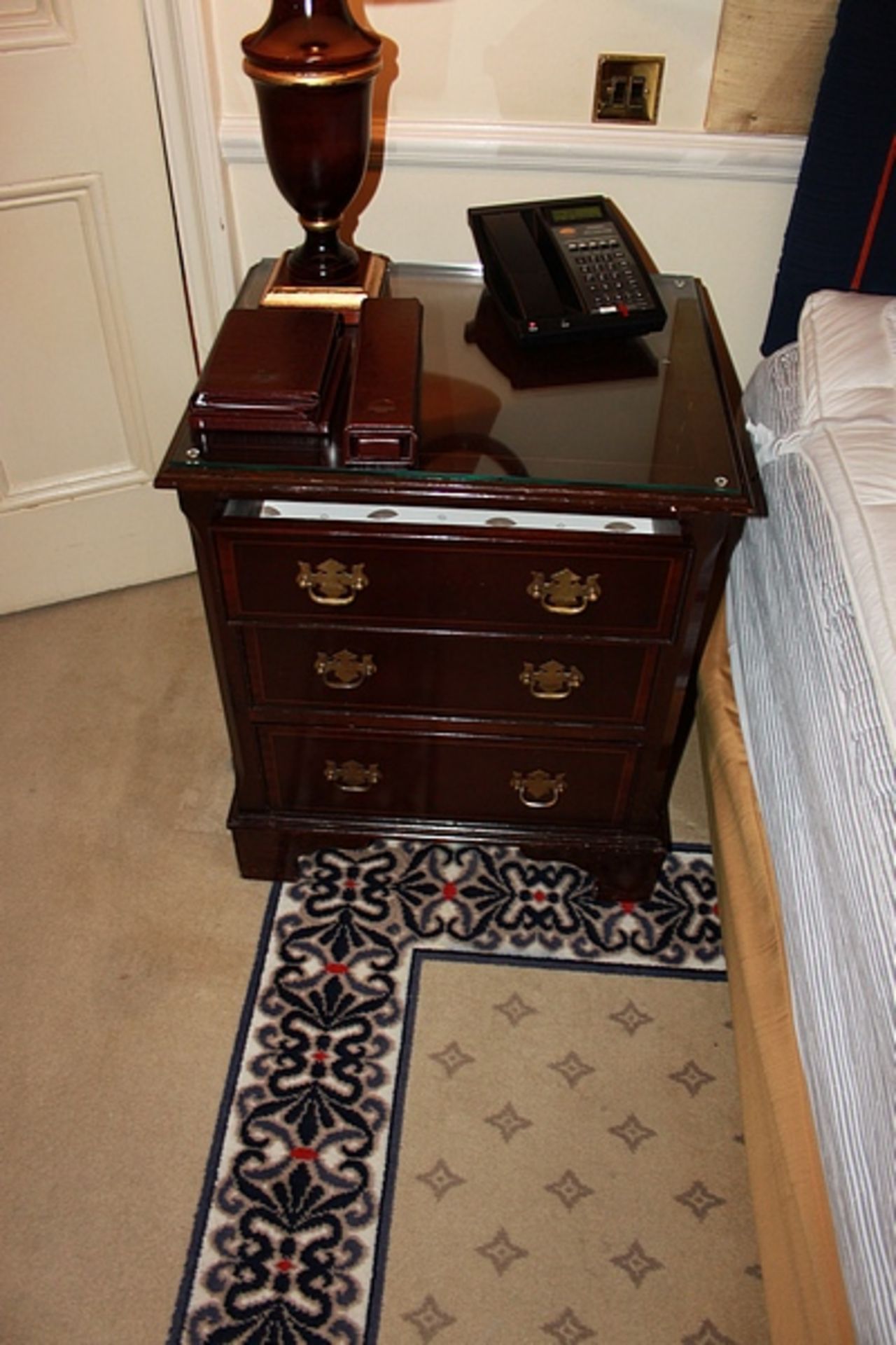 A pair of mahogany bedside cabinet chests in the Georgian style three drawers below, of dovetail