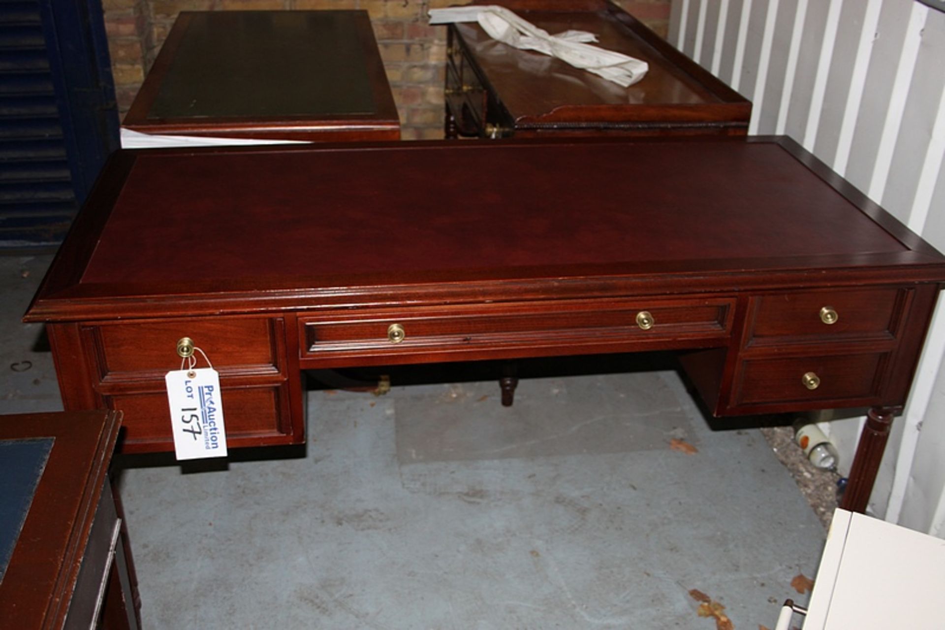A Georgian style mahogany writing desk the moulded top above a frieze centre drawer flanked