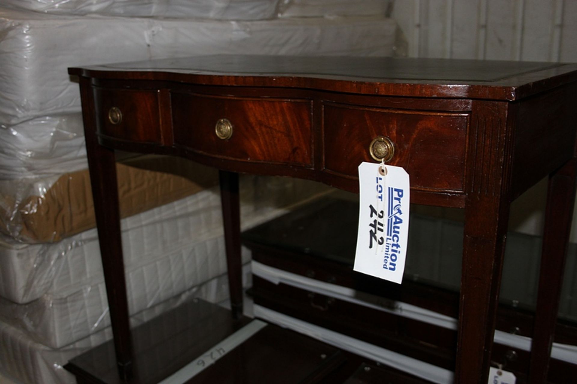 A mahogany Georigian style writing desk tooled leather inlay top bow fronted with three drawers