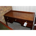 A Georgian style mahogany writing desk the moulded top above a frieze centre drawer flanked