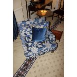 A traditional easy armchair upholstered in a blue broccade fabric casters to front 700 x 800mm