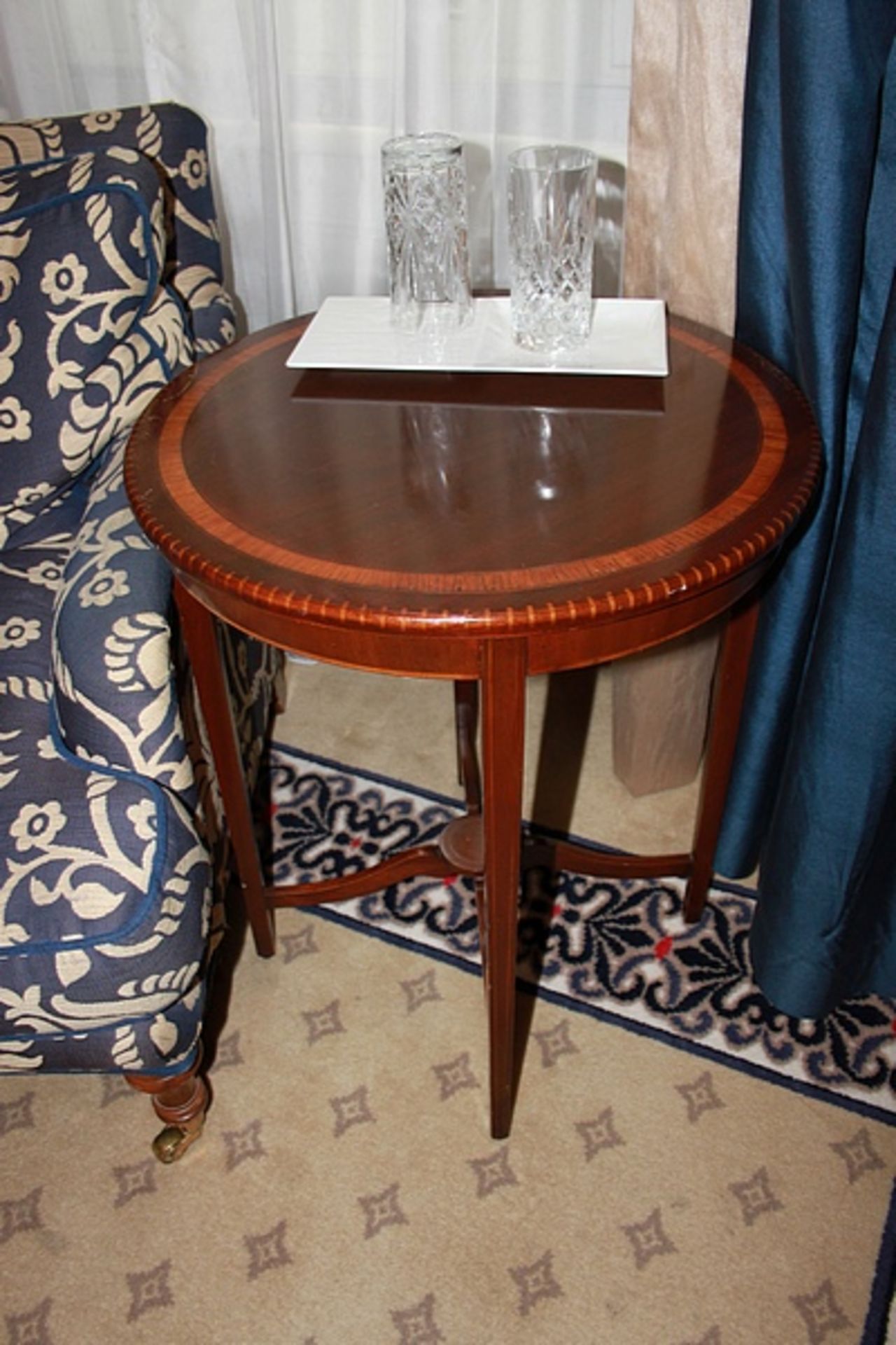 A Georgian style mahogany circular top table with inlay top and mounted with low stretcher